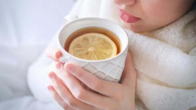 Young,Ill,Woman,Drinking,Hot,Tea,With,Lemon,At,Home,