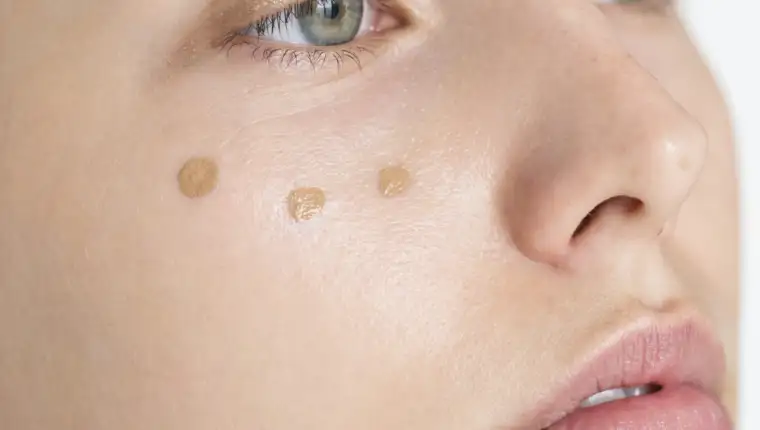 Portrait of white woman doing her daily makeup routine