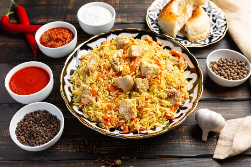 National Uzbek pilaf with meat in a cast-iron skillet