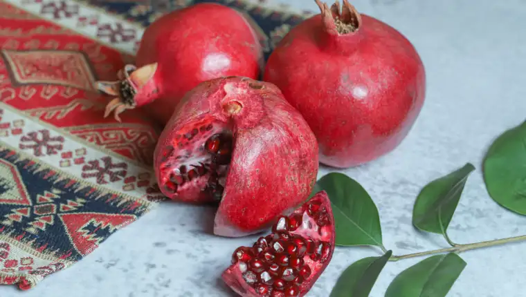 Fresh ripe pomegranates on stone background