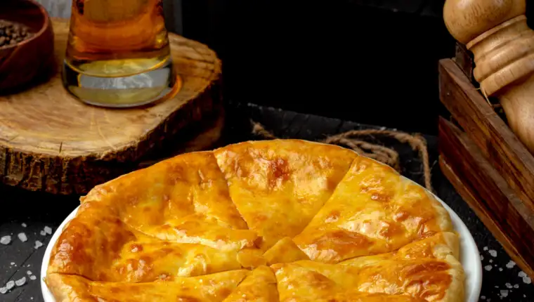 side view of ossetian pie with cheese on the table