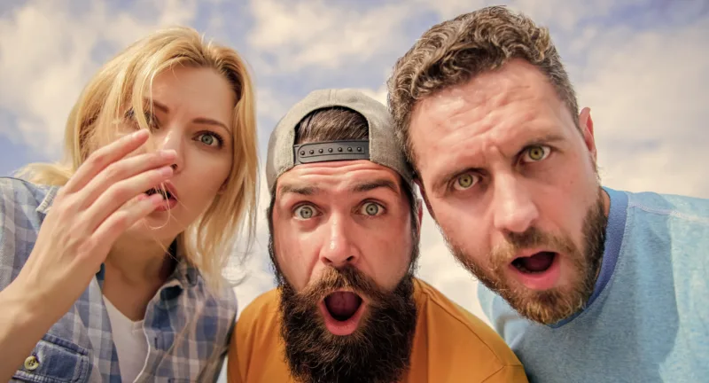 Friends shocked faces looking at you. That is impossible. Shocking news. Amazed surprised face expression. How to impress people. Shocking impression. Men with beard and woman looking shocked. No way