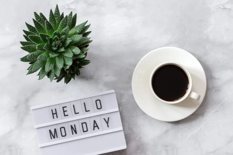 Office or home table desk. Lightbox text Hello monday, cup of coffee, succulent on marble background Concept Copy space Flat lay Top view