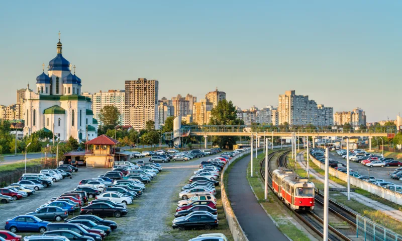 Cathedral of the Holy Trinity and a light rail tram in Troieshchyna - Kiev, Ukraine