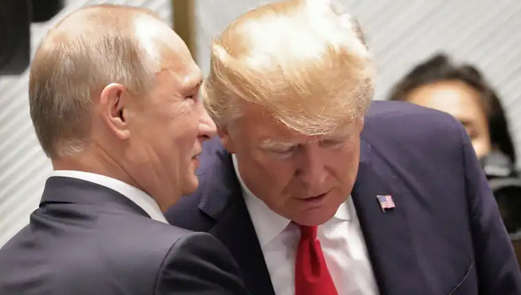 U.S. President Donald Trump and Russian President Vladimir Putin talk before a session of the APEC summit in Danang