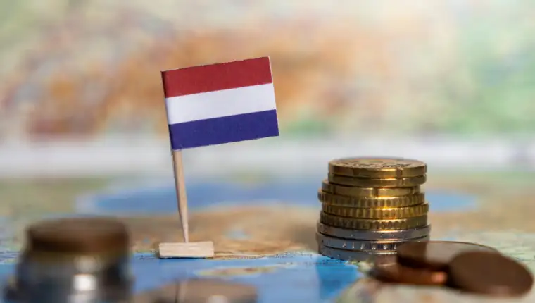 dutch flag with euro coins on a world map, symbolizing the netherlands economy, financial stability, and international trade connections