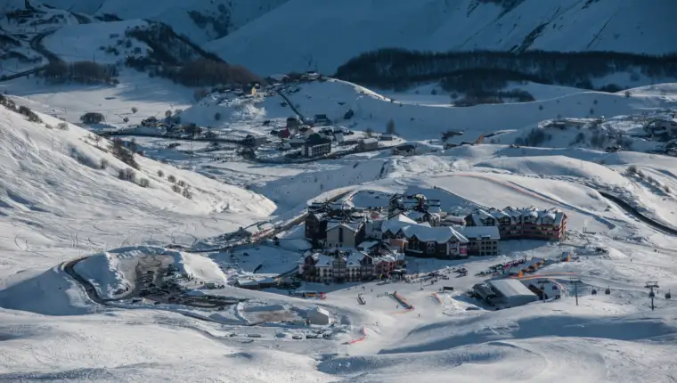 Snowy winter mountains in sun day. Georgia, from ski resort Guda