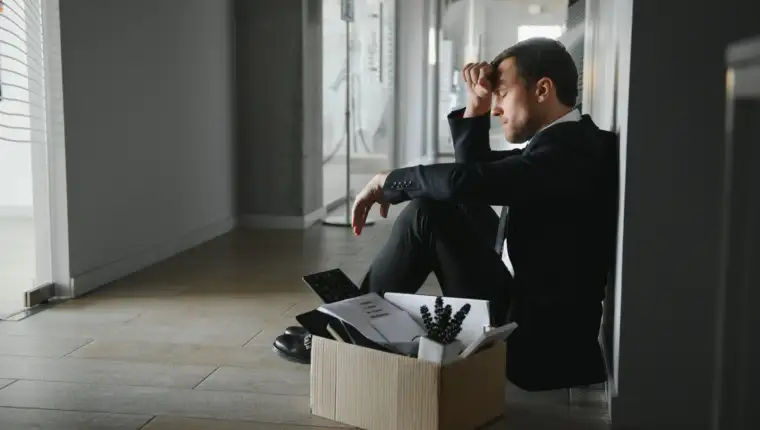 Sad Fired. Let Go Office Worker Packs His Belongings into Cardboard Box and Leaves Office. Workforce Reduction, Downsizing, Reorganization, Restructuring, Outsourcing. Mass Unemployment Market Crisis