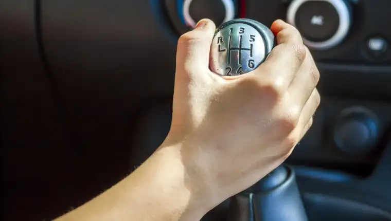 Driver hand shifting gear shift knob manually, selective focus