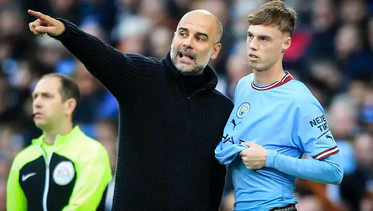 Pep-Guardiola-Manchester-City-Manager-speaks-with-Cole-Palmer-Premier-League-April-15-2023