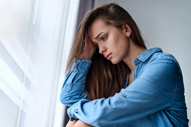 Young upset depressed lonely pensive woman with sad eyes in a sh