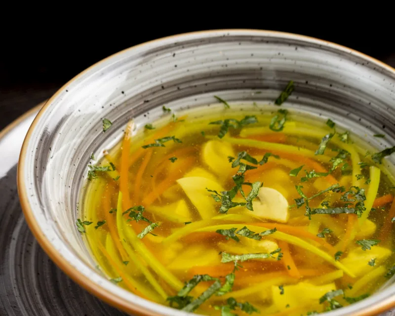 vegetable soup served with greens