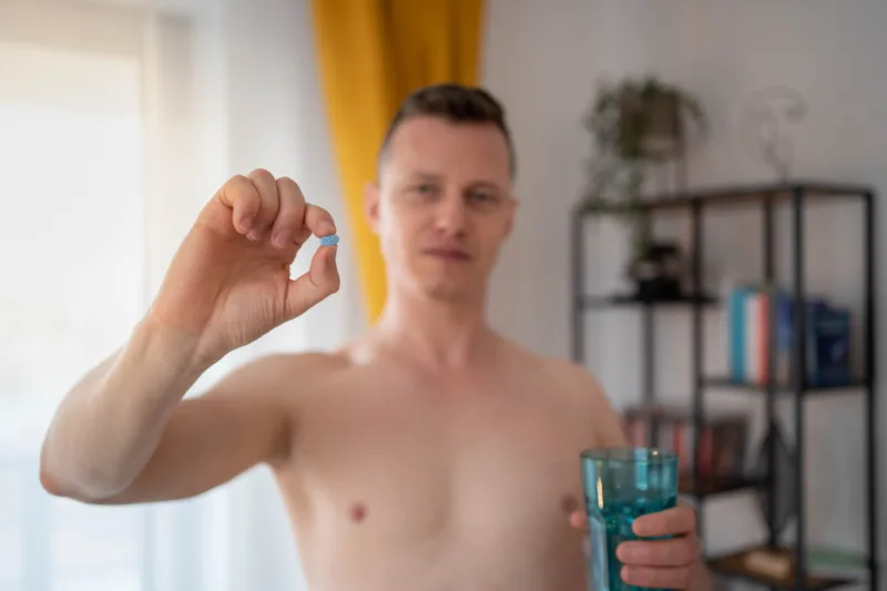 A young man takes a prep in a pill. HIV prevention concept. AIDS prevention concept.