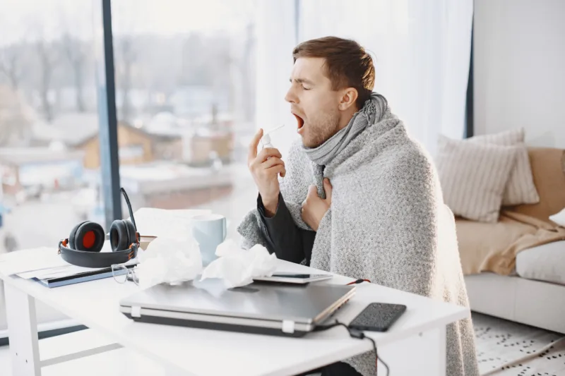 Young man ill with flu in office