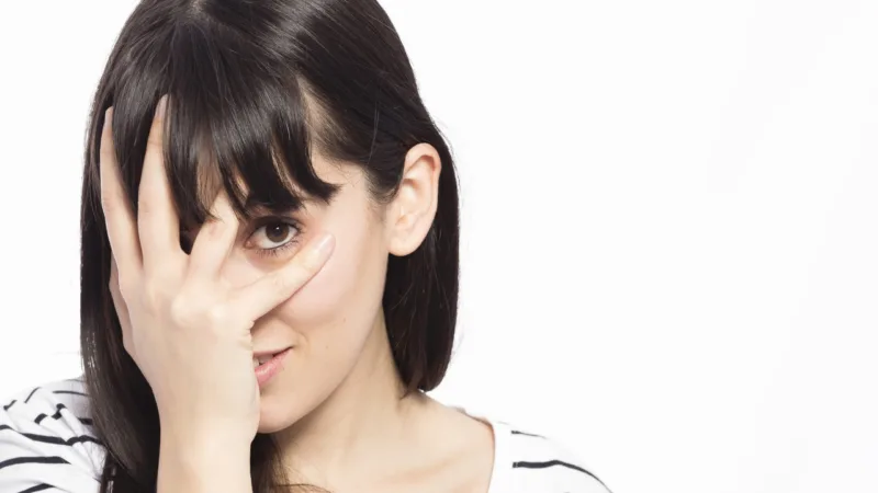 young-woman-covering-face
