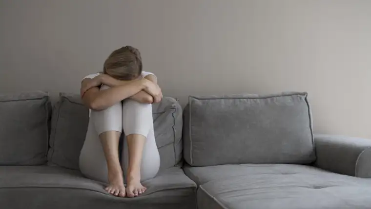 full-shot-woman-sitting-couch