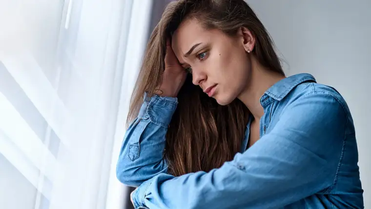 Young upset depressed lonely pensive woman with sad eyes in a sh