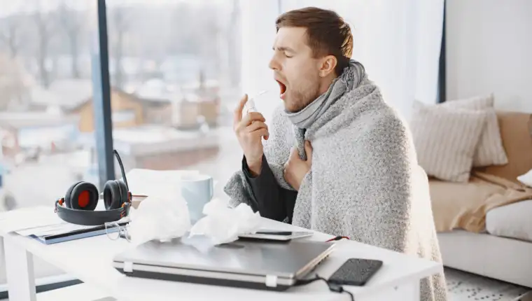 Young man ill with flu in office