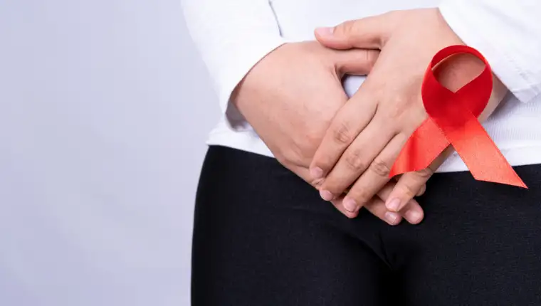 Woman hands holding her crotch with Red AIDS awareness ribbon on grey background. Medical, healthcare for advertising concept.