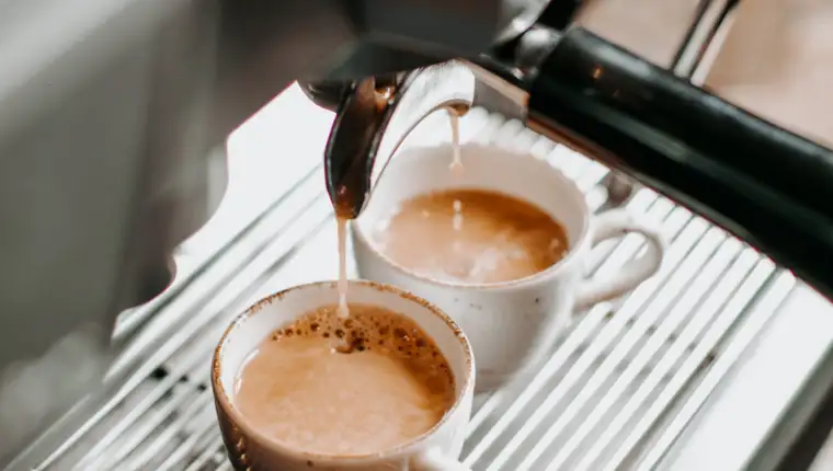 two espresso cups under coffee engine _