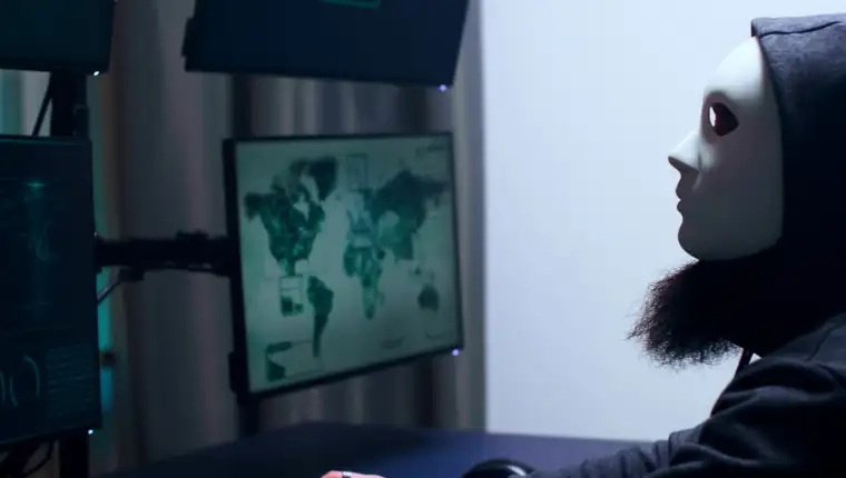 Side view of dangerous cyber criminal with white mask