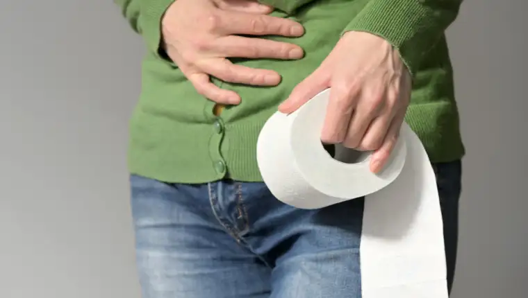 Woman Holding Her stomach And Toilet Paper Roll