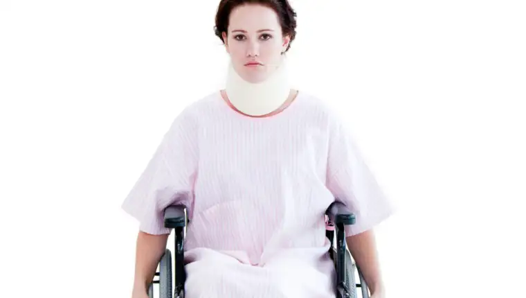 Portrait of a young woman with a neck brace sitting on a wheelch