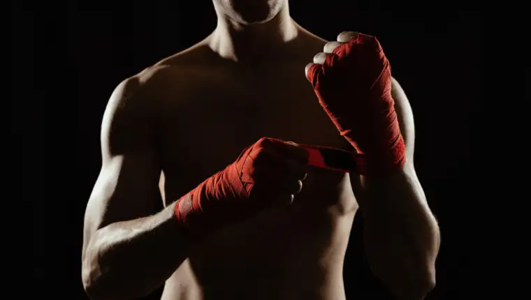 Close up boxer bandaging hands