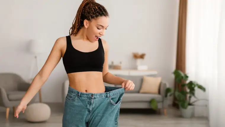 Black Female After Great Weight Loss Wearing Big Jeans Indoors