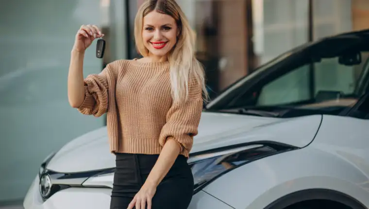 Woman holding keys from her new car