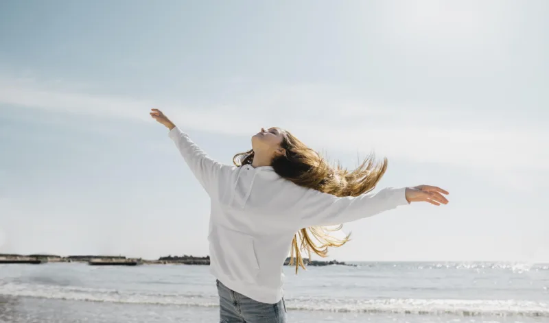 young-woman-enjoying-ocean-breeze