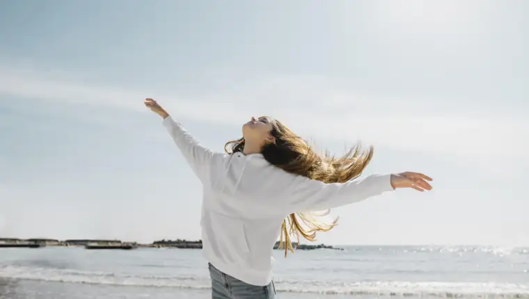 young-woman-enjoying-ocean-breeze