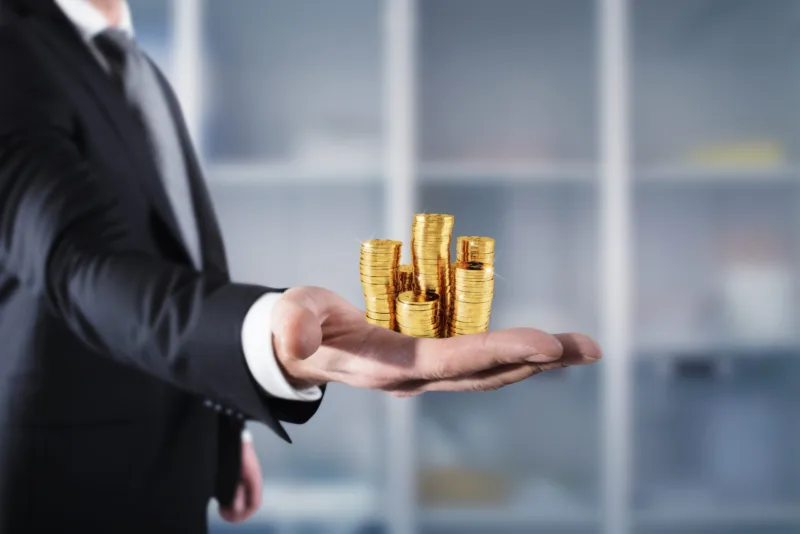 Businessman hold piles of money. Concept of success and company growth