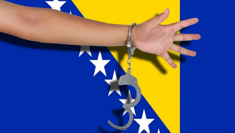 handcuffs with hand on Bosnia Herzegovina flag