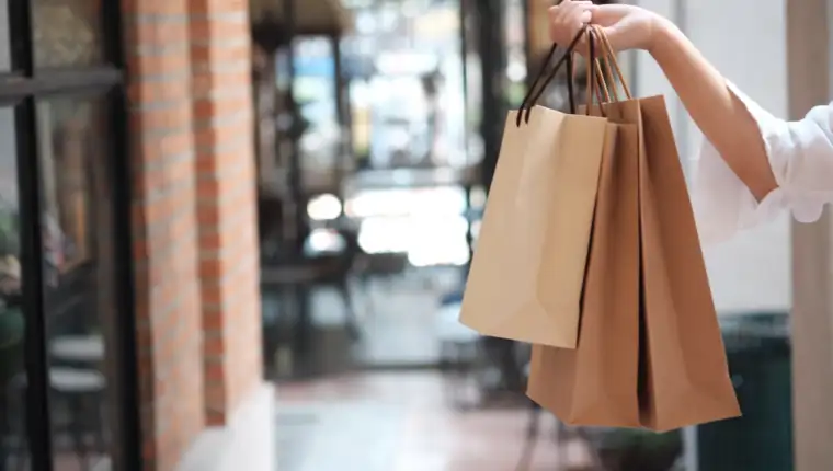 midsection-woman-holding-shopping-bags