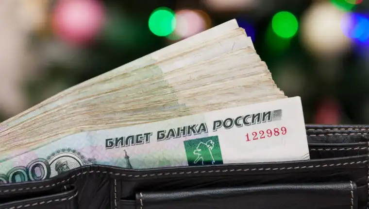 Russian money in the black leather wallet on the multicolored defocused bokeh lights background