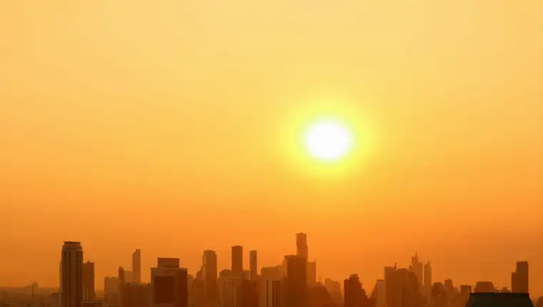 The bright sun rising over the city with copy space