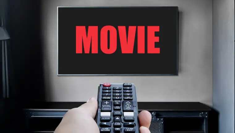 hand-hold-black-remote-control-television-with-red-text-movie-display-television-living-room