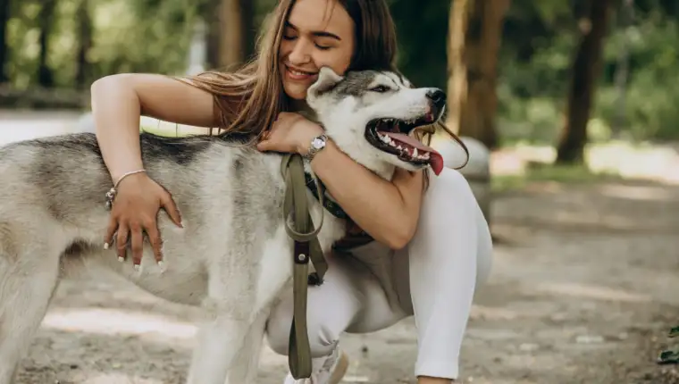 Woman with her husky dog in the park
