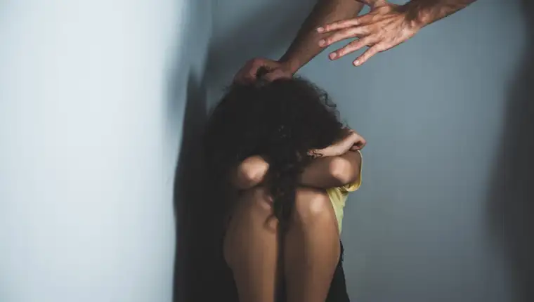 man beat baby girl on dark background