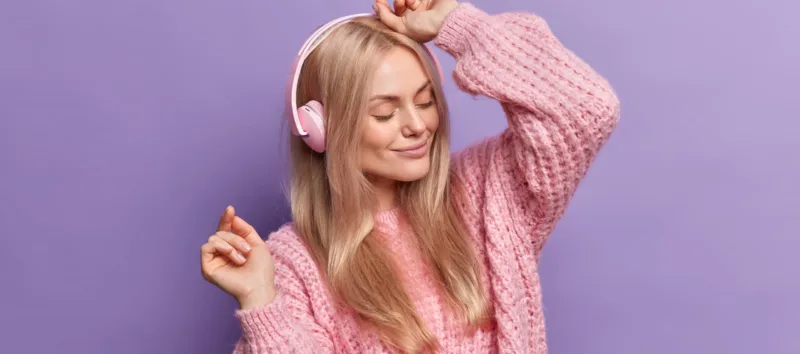 pretty-woman-dances-carefree-enjoys-every-tune-song-listens-music-headphones-closed-eyes