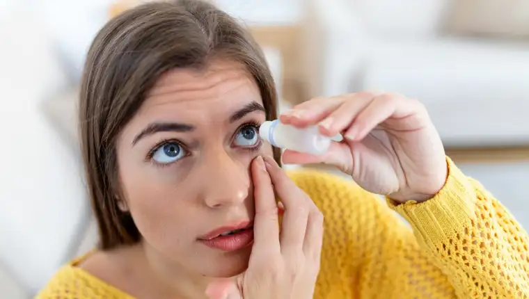 Woman using eye drop, woman dropping eye lubricant to treat dry eye or allergy