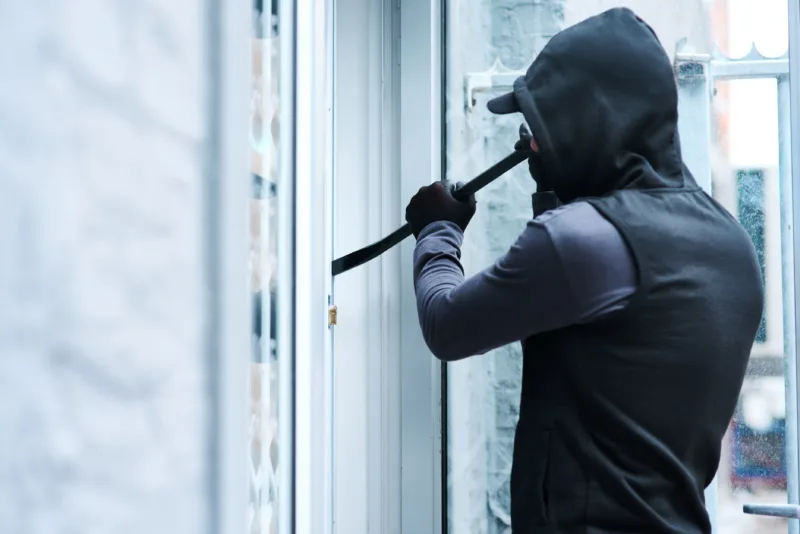 Man criminal crowbar house crime home invasion breaking entering attempt with tool apartment robbery burglary trespassing property security breach owners safety risk