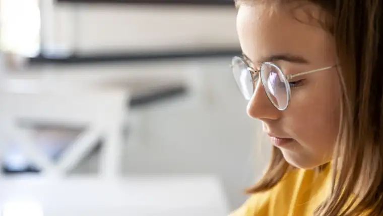 Teen girl glasses blurred background closeup