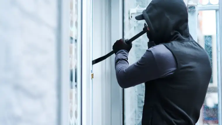 Man criminal crowbar house crime home invasion breaking entering attempt with tool apartment robbery burglary trespassing property security breach owners safety risk