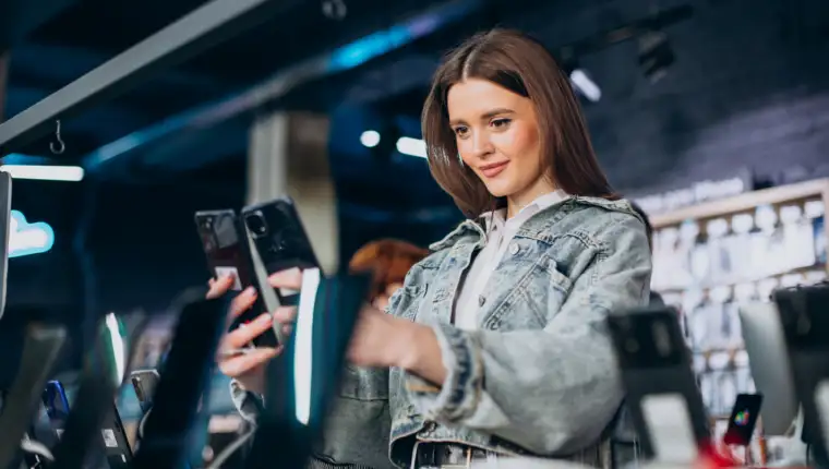 Woman choosing phone technology store