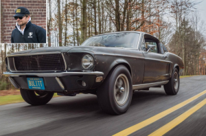 Najpoznatija automobilska jurnjava na slici Mustang stari sive boje na cesti okolo puma u ćošku Bradley Cooper sa kačketom na glavi tamno plava jakna smije se